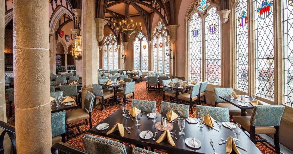 inside looks at tables and stain glass windows of Cinderella’s Royal Table