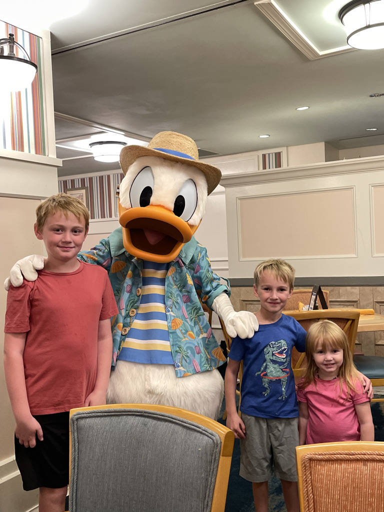 children standing with Donald duck