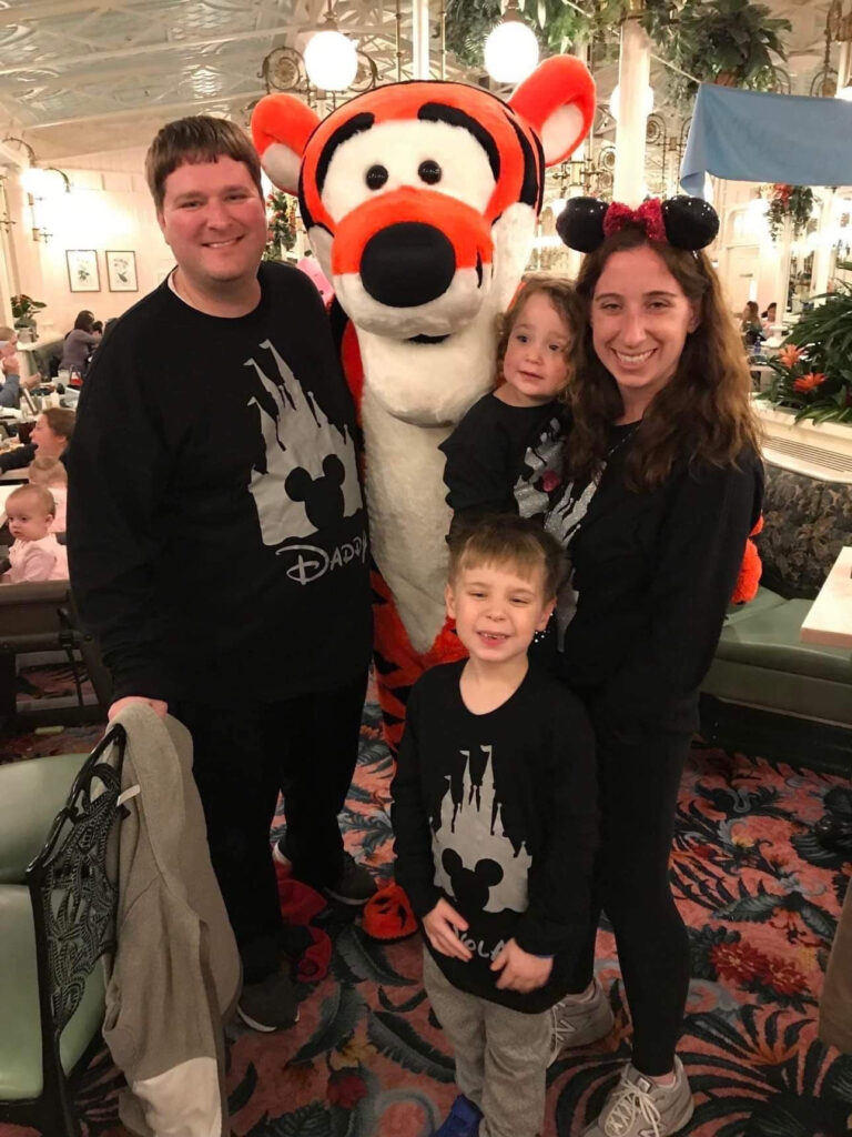 Family of 4 standing with Tigger for a photo at The Crystal Palace 